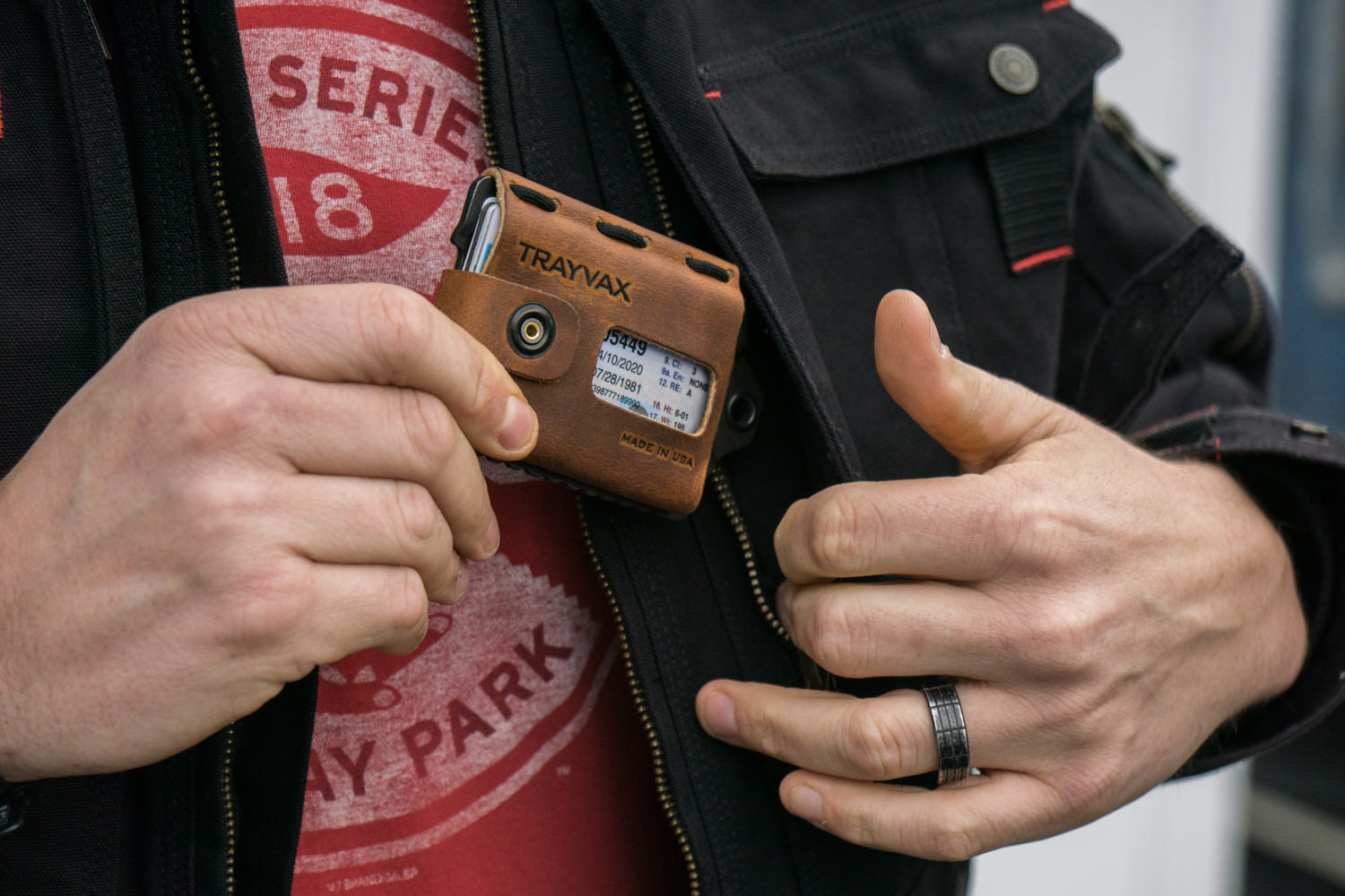 Tobacco Brown Top Grain Leather Wallet With Guy placing it in Jacket Pocket