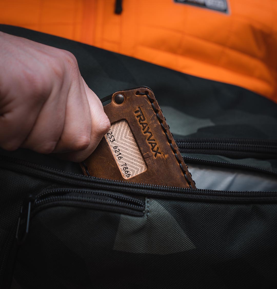 Close up of Man placing Ascent Wallet in his pocket