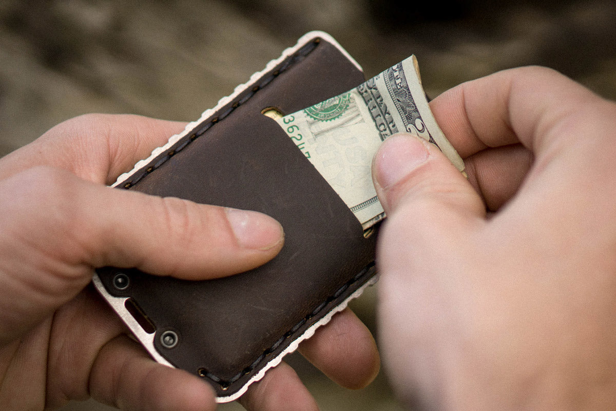 Man Holding Ascent Wallet With Back of wallet Showing How Folded Cash Fits In wallet